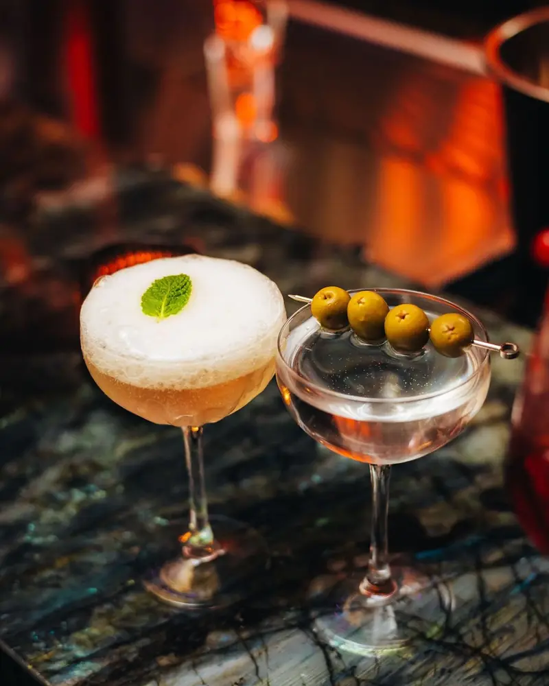 A sour and a martini with olives on a DREAMERS Friday at Mayfair