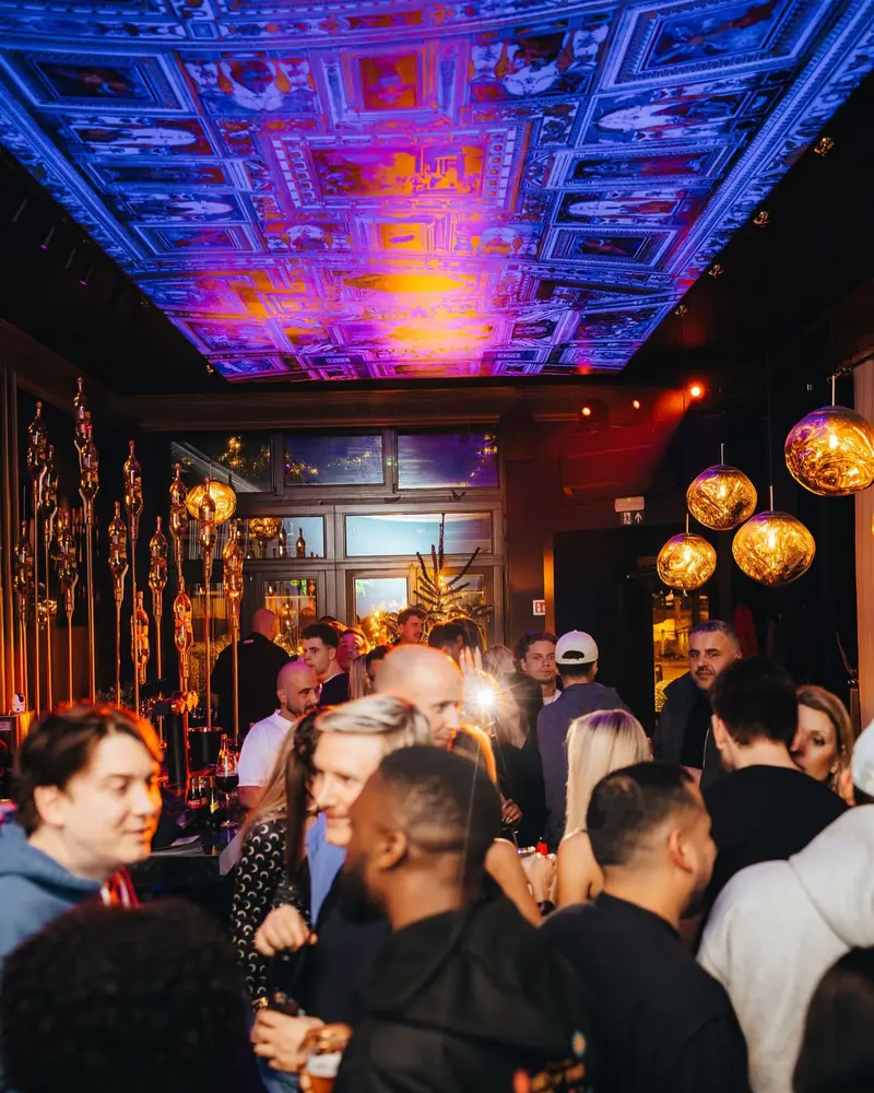A full room under the painted ceiling on a SACRO Wednesday at Mayfair