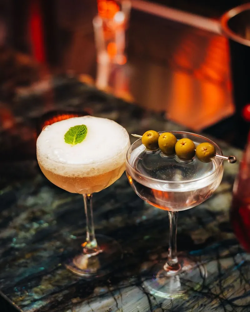 A sour and a martini with olives on a DREAMERS Friday at Mayfair