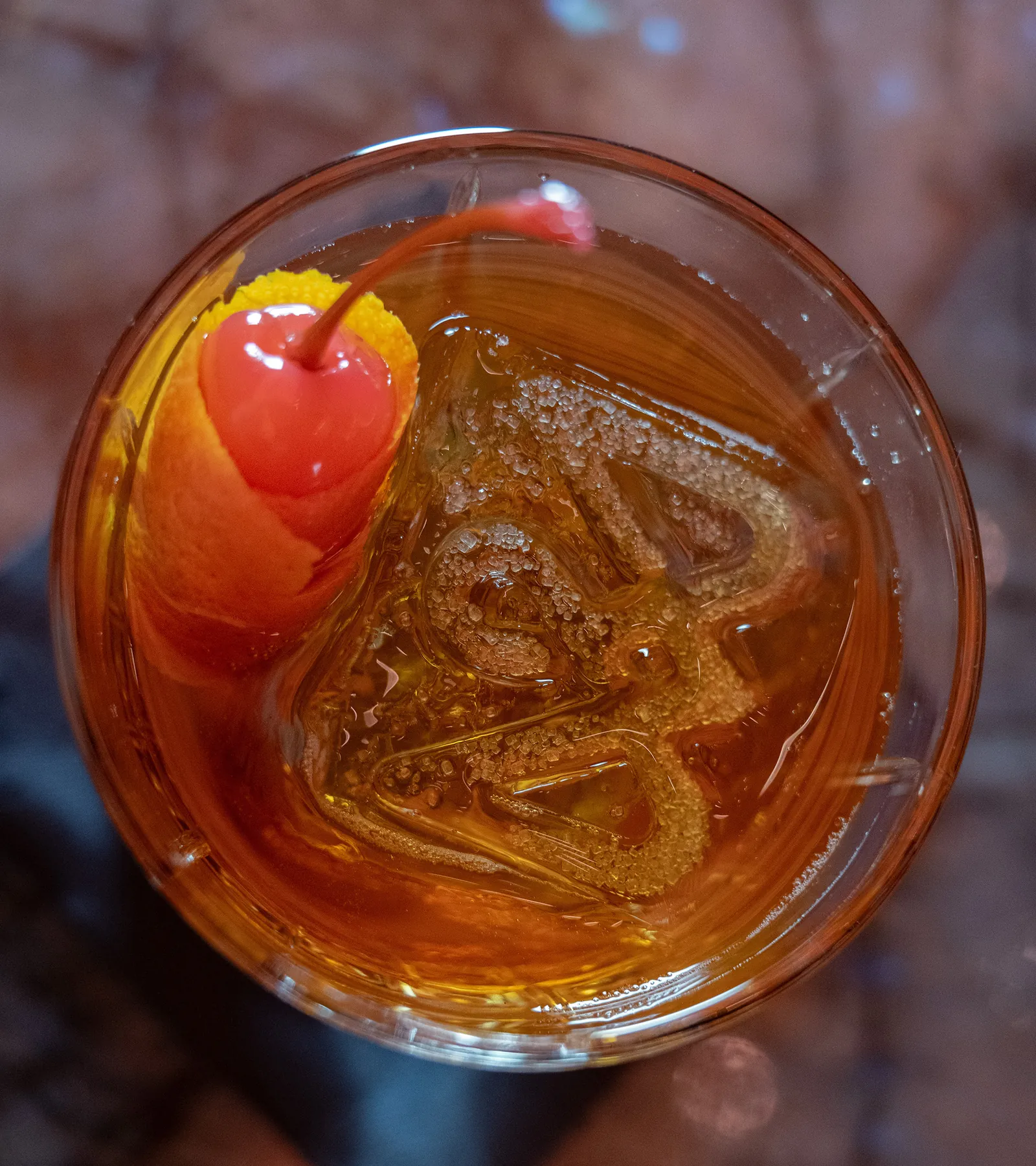 An amber cocktail served over clear ice