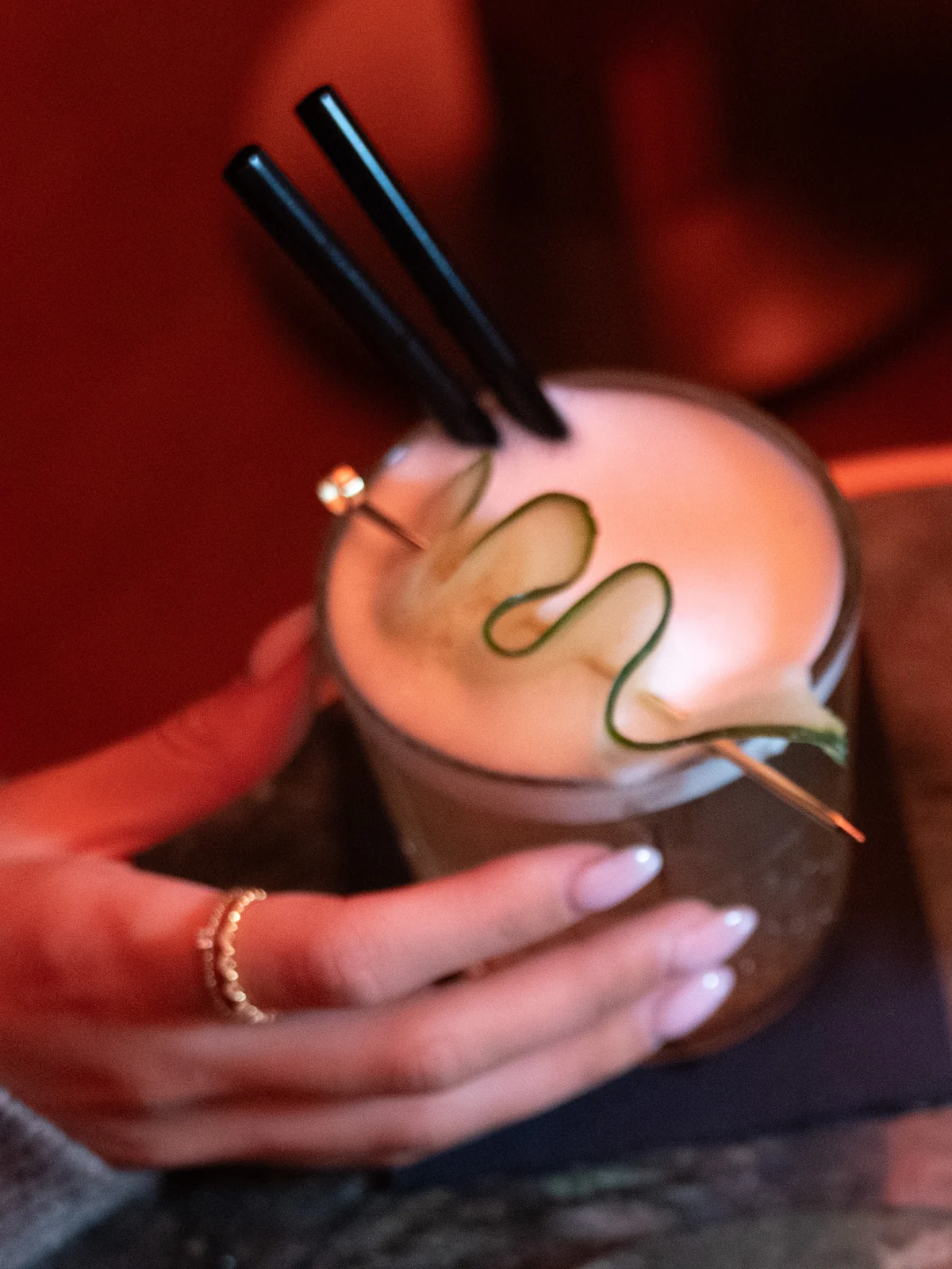 Two cocktails passed across the table at Mayfair