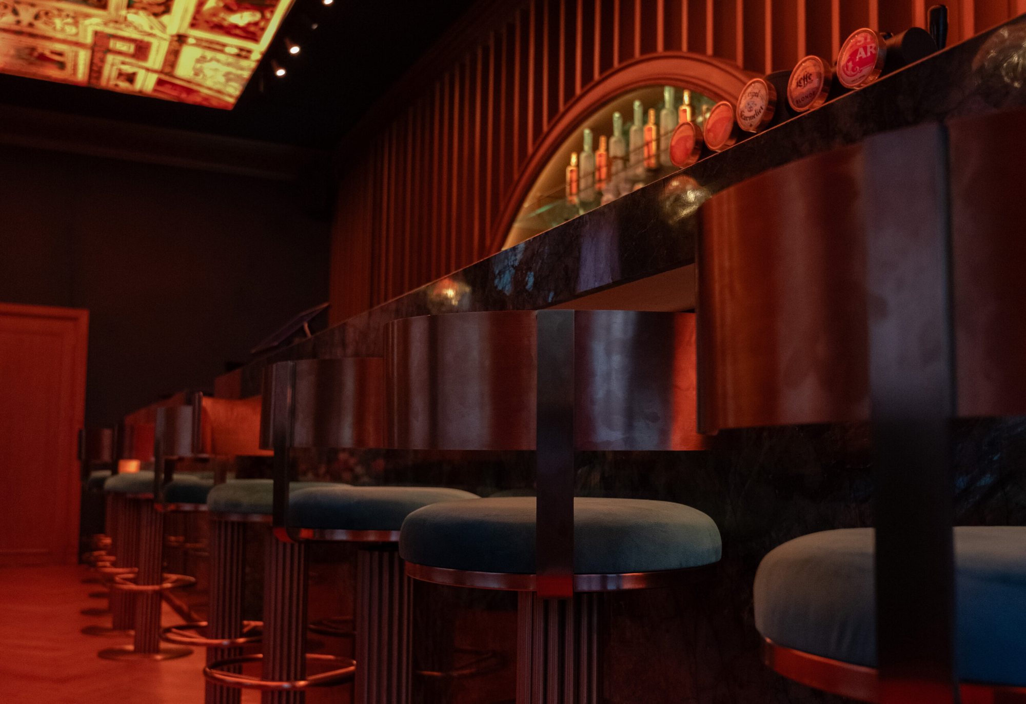 The curved bar at Mayfair with its stools and booths